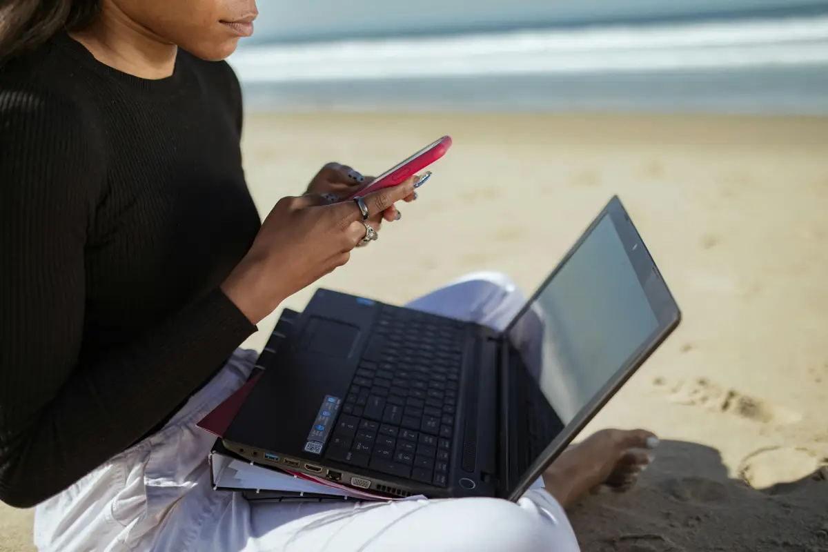 Person working on a laptop at the beach