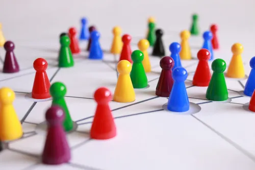 Game pieces representing people on a white board