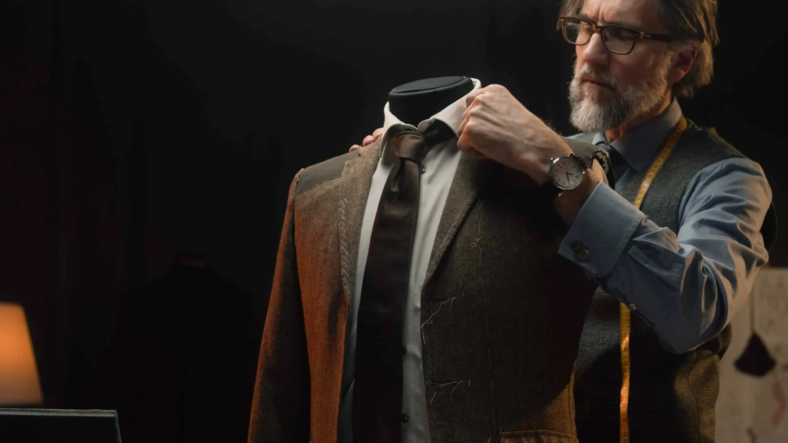 Male tailor works on elegant business suit