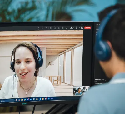 A man wearing headphones is in a video call with a woman wearing headphones.