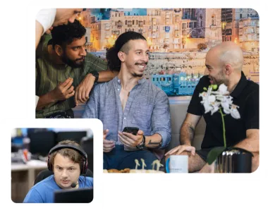 A group of people having a conversation together. The person in the middle is holding their phone. At the bottom left is a man wearing headphones looking at a monitor.